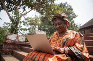 60-year-old-african-woman-uses-her-laptop-women-technology-concept_404612-360